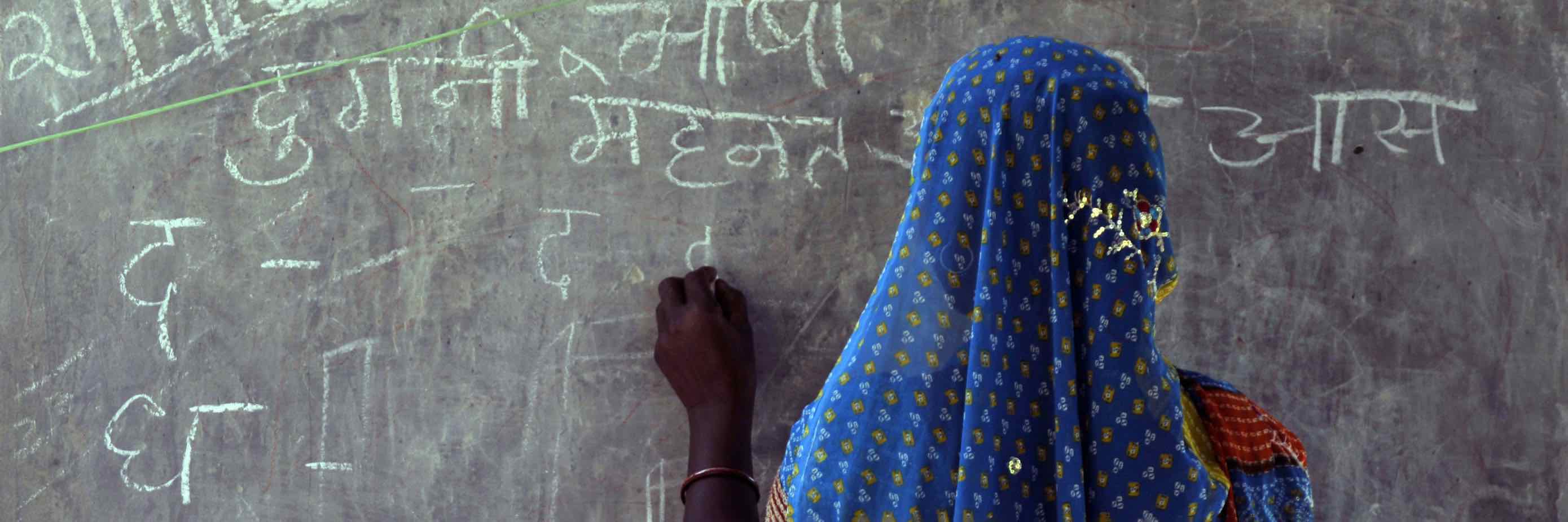 a young student at a classroom blackboard